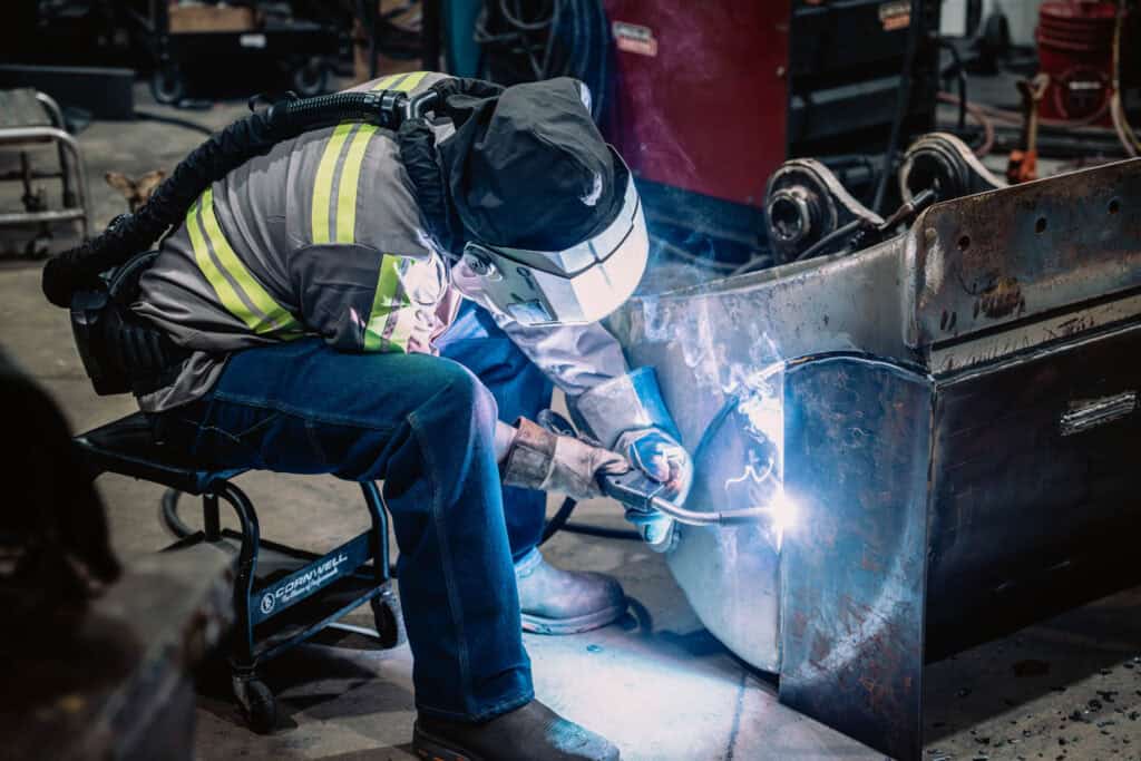 Welding technician performing metal fabrication at Wesco Machine Works.