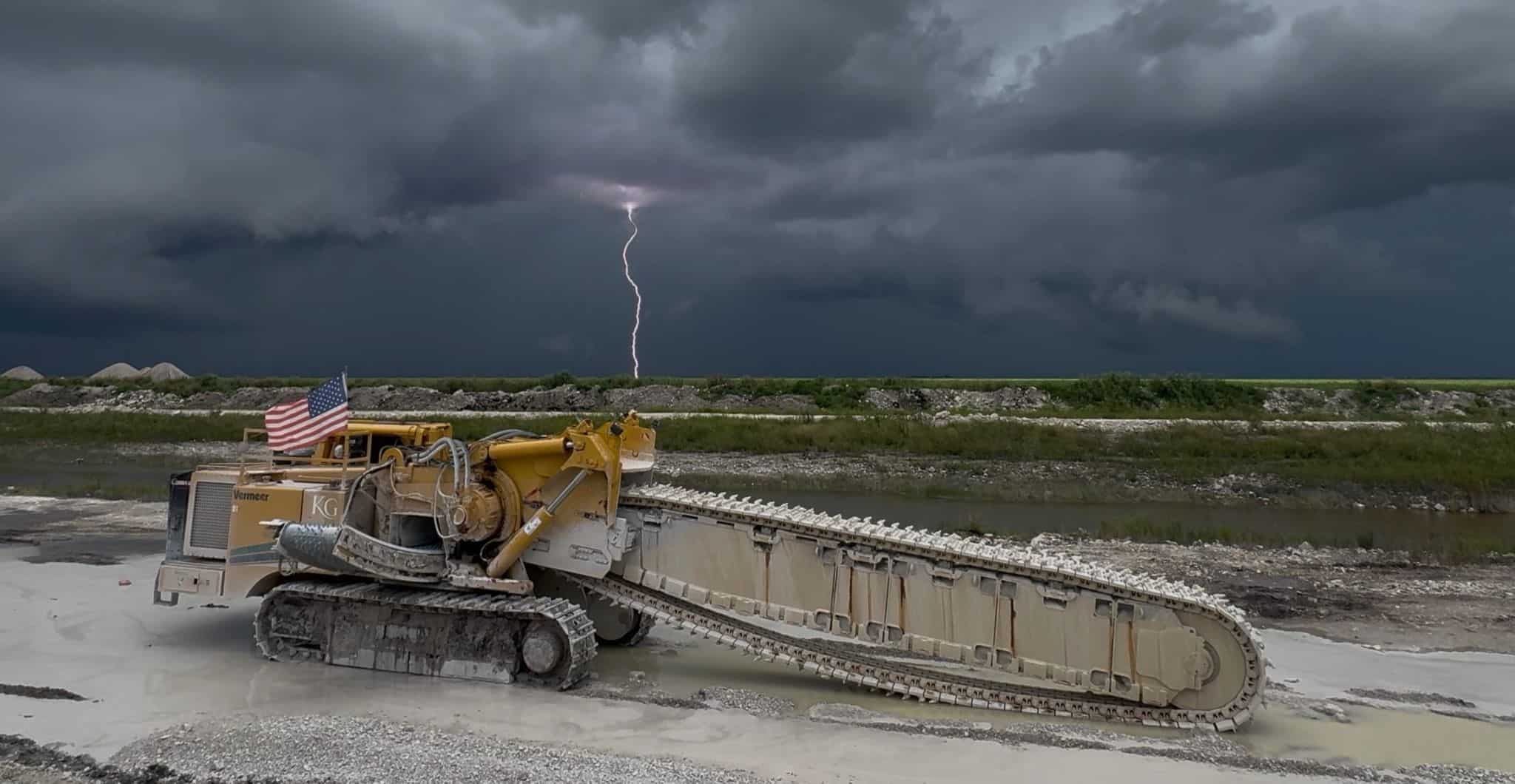 Heavy construction machinery at Wesco Machine Works during storm.