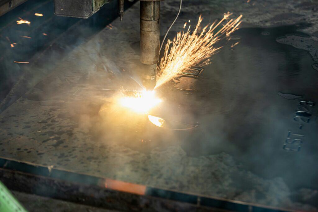 Welding metal with sparks at Wesco Machine Works, showcasing precision fabrication and metalworking.